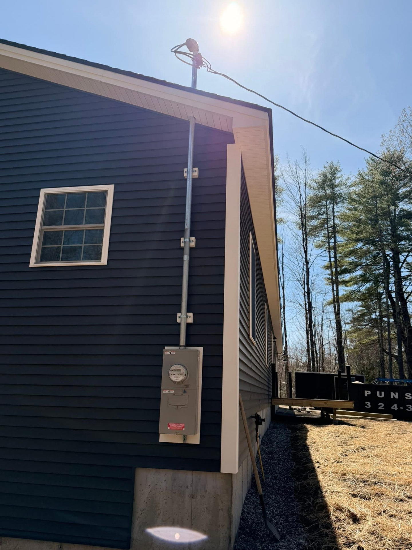New service mast, meter, and disconnect installed by Goodwin Electric LLC on a Maine home