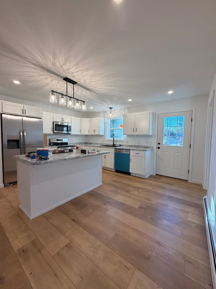Kitchen with new pendant and recessed lighting installed