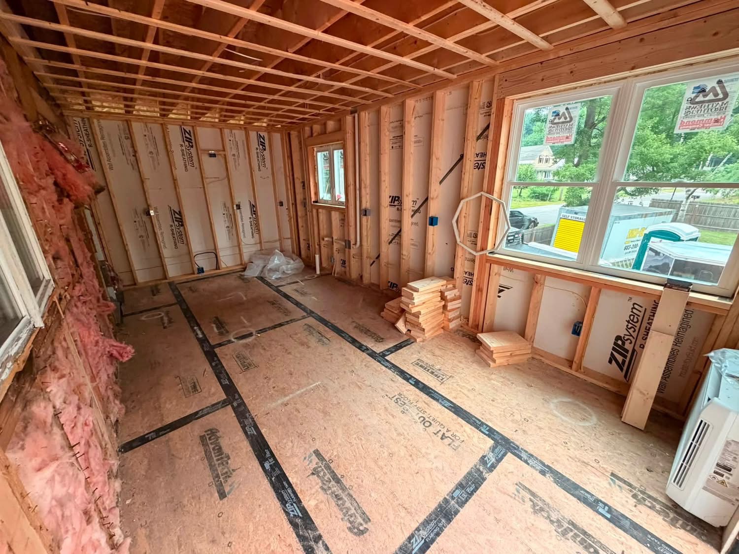 Rough-in wiring in a framed addition under construction
